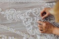 The tailor is correcting her white ornament for the future wedding dress Royalty Free Stock Photo