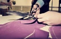 Tailor cutting fabric for bespoke suit