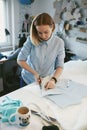 Tailor Cutting Fabric With Scissors In Atelier