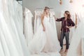 Tailor giving young woman advice about her dress.