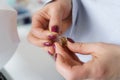 Tailor hands hold needle and spool of thread. Close up view of seamstress hands with tools Royalty Free Stock Photo