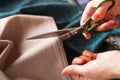 Tailor. Hands notch tailor tailor`s scissors cloth. Close Up. Royalty Free Stock Photo