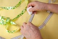 Tailor hands working with yellow fabric. Selective focus