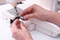 The tailor places the bobbin in the bobbin cap of the sewing machine. Royalty Free Stock Photo