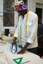 A tailor ironing fabric in his sewing shop Royalty Free Stock Photo