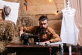 Tailor man sews clothes