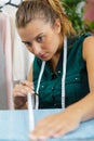 tailor measuring fabric on table