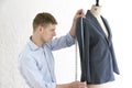 Tailor Measuring Suit On Mannequin In Studio