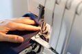 Tailor overcasting the edge of fabric on overlock