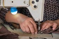 Tailor pushes sew fabric repairs with sewing machine Royalty Free Stock Photo