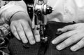 Tailor`s hands close-up sew clothes on an old retro sewing machine. Tools for a tailor, fashion designer or seamstress Royalty Free Stock Photo