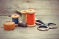 Tailor's tools - the old scissors, spools of thread, tape centim Royalty Free Stock Photo