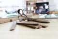 Tailor`s tools, old scissors, wooden meter and ruler on the sartorial work table