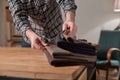 Tailor Selects wool from the stack. Young man working as a tailor and using a sewing machine in workshop. Royalty Free Stock Photo