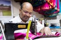 Tailor sewing fabric with old sewing machine at workshop at Souq in Manama Bahrain