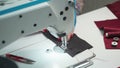 Tailor sewing order on electric machine, close-up photo