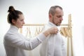 Tailor standing near male client measuring back. Tailor woman taking measures for new business shirt using tape meter Royalty Free Stock Photo