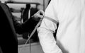 Tailor taking wrist measurements from client Royalty Free Stock Photo