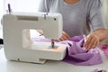 Tailor woman with sewing machine stitching fabric