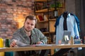 Tailor at work. Confident young man working at the tailor shop Royalty Free Stock Photo