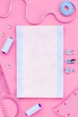 Tailor work place with thread, fabric. Sewing as hobby. Pink background top view space for text