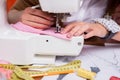 Tailor working on sewing machine.