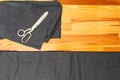 Tailoring Concepts. Old Metal Rusty Scissors Placed Together with Black Fabrics on wooden Surface Royalty Free Stock Photo