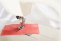 Tailoring process - sewing machine with needle, thread and fabric. Item of clothing Royalty Free Stock Photo