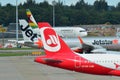 Tails of Air Zimbabwe Boeing 767, Jetstar Asia Airbus A320 and Air Belin Airbus A320 at Changi Airport