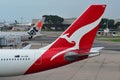 Tails of Jetstar International and Qantas aircraft belonging to the same family at Changi Airport