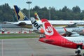 Tails of Singapore Airlines, Air Zimbabwe, Jetstar Asia and Air Berlin aircraft at Changi Airport