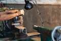 Professional machinist : man operating lathe grinding machine - metalworking industry concept. Mechanical Engineering control lath Royalty Free Stock Photo