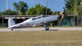 Tailwheel undercarriage grey two seats in tandem airplane side view on runway Royalty Free Stock Photo