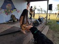 Taimane and band playing at Hawaii Polo Club as dog watches