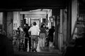 A man with his back walking through a food stand at arcade in Tainan street