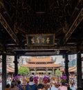 Daytime shot of many people visiting Lungshan Temple