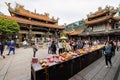 Daytime shot of many people visiting Lungshan Temple