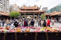 Daytime shot of many people visiting Lungshan Temple