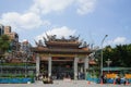 Taipei, Taiwan -April 19, 2018 : People walking and traffic in front of the gate of LONGSHAN Temple