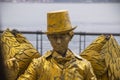 TAIPEI, TAIWAN - Jan 2020: Tamsui old Street artist performing with golden hat. Golden painted artists on famous attraction tamsui