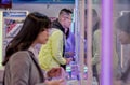 TAIPEI, TAIWAN - JANUARY 03: Unnamed young people tries to catch prizes with crane catcher machines in Shilin Market in Taipei on Royalty Free Stock Photo