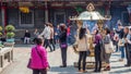 Crowd of people praying and offering incense with golden giant incense burner at Longshan temple. Royalty Free Stock Photo