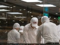 Workers in a kitchen making xiaolongbao or steamed dumplings at Din Tai Fung restaurant.