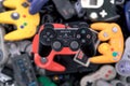A Sony Playstation 2 Controller Hovering over a Pile of Retro Video Game Controllers Royalty Free Stock Photo