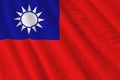 Taiwan flag with big folds waving close up under the studio light indoors. The official symbols and colors in banner