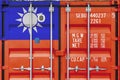 Taiwan flag depicted on metal doors of shipping cargo container outdoors in docks area