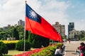 Taiwan national flag waving in the wind with tourists near the area of National Dr. Sun Yat-Sen Memorial Hall in Taipei, Taiwan