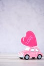 Taiwan, Tainan - April 17, 2018: Little beetle pink car carries a heart with love in blank background for text, Valentine`s Day co