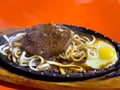 Taiwanese style sizzling steak with noodles and egg in traditional night market