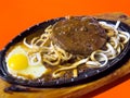 Taiwanese style sizzling steak with noodles and egg in traditional night market